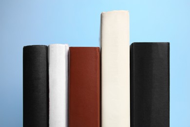 Photo of Collection of books on light blue background, closeup