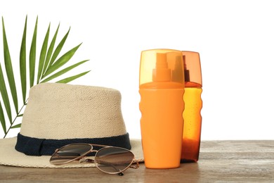 Photo of Sun protection products and beach accessories on wooden table