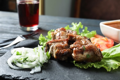 Tasty shish kebab served on slate plate, closeup