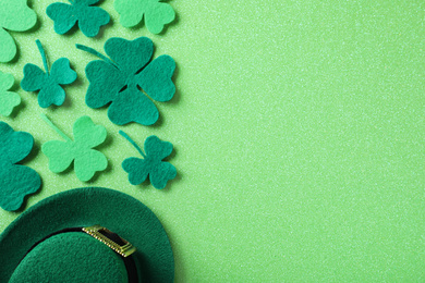 Photo of Flat lay composition with clover leaves on light green background, space for text. St. Patrick's Day celebration