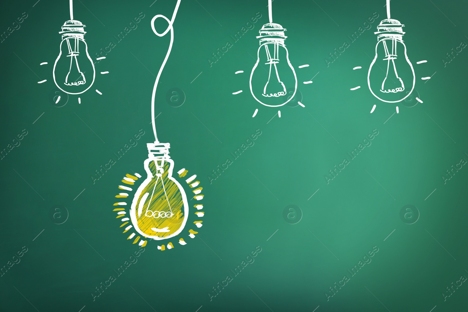 Image of Idea concept. Light bulbs drawn on green chalkboard