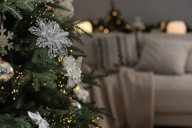 Photo of Christmas tree with festive decor indoors, closeup. Space for text