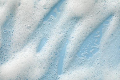 White washing foam on color background, top view