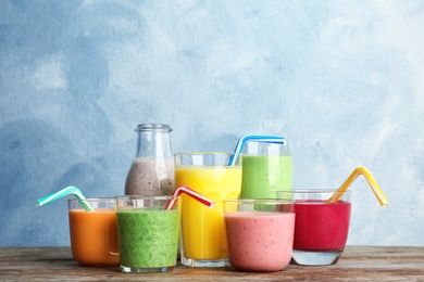 Glassware with delicious detox smoothies on table