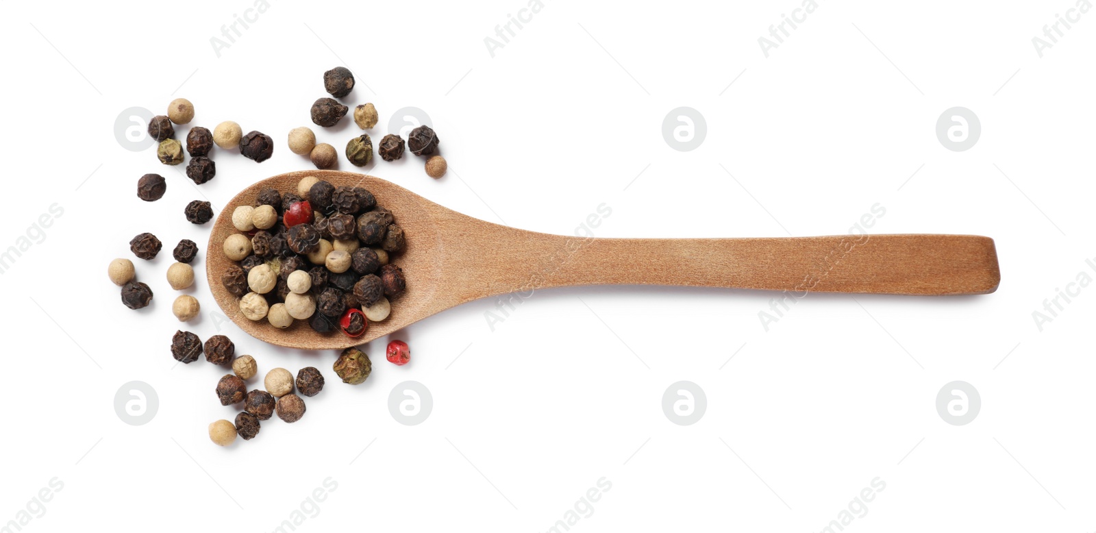 Photo of Aromatic spices. Different peppers in wooden spoon isolated on white, top view