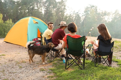 People having lunch near camping tent outdoors