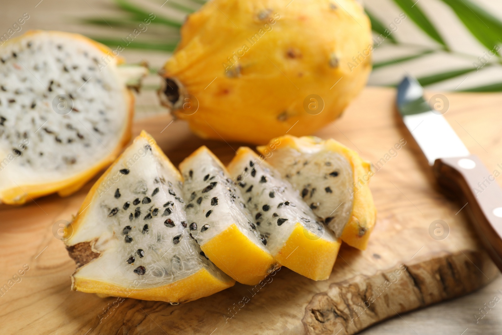 Photo of Delicious cut dragon fruit (pitahaya) on wooden board, closeup