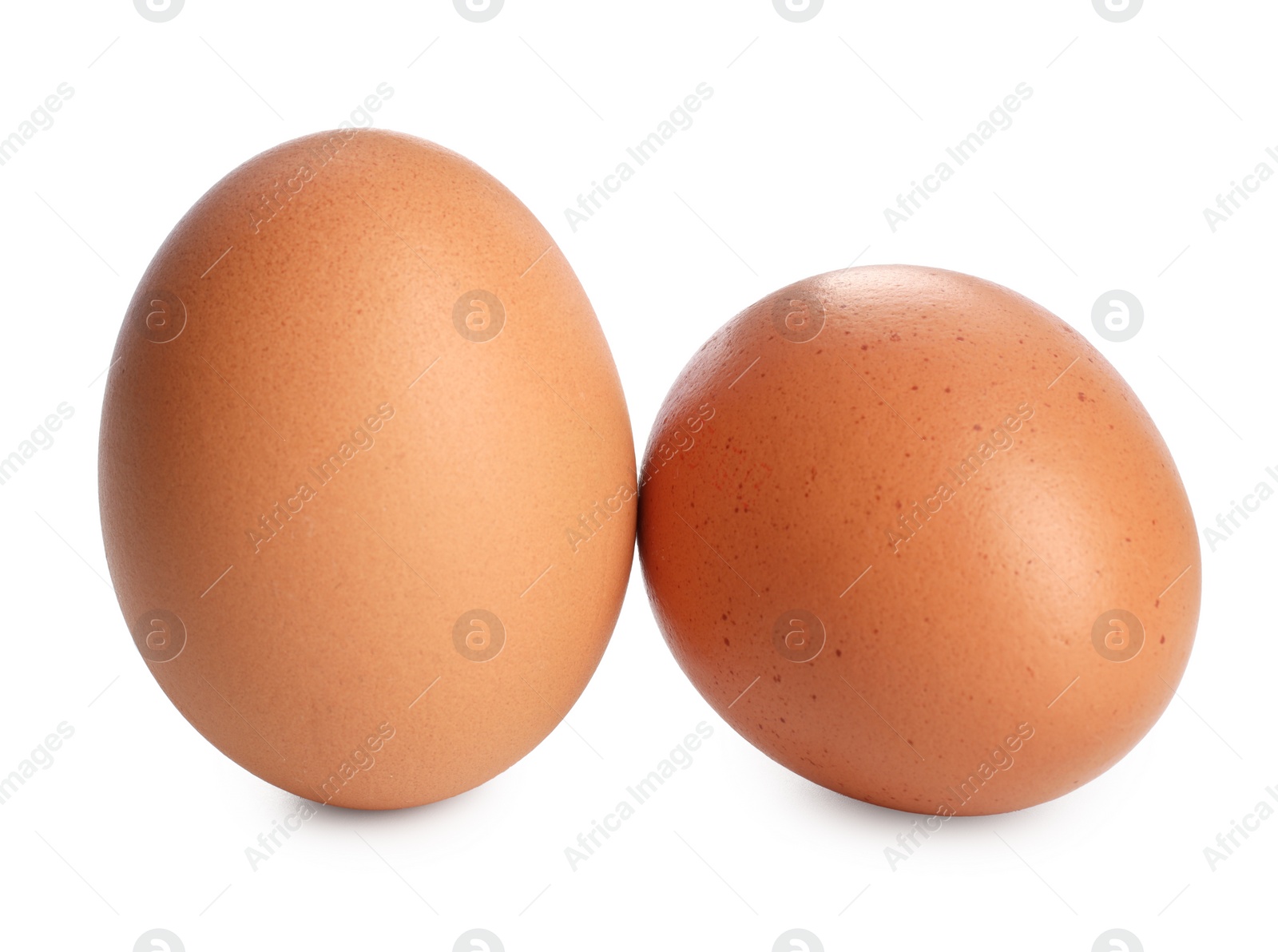 Photo of Two raw chicken eggs isolated on white