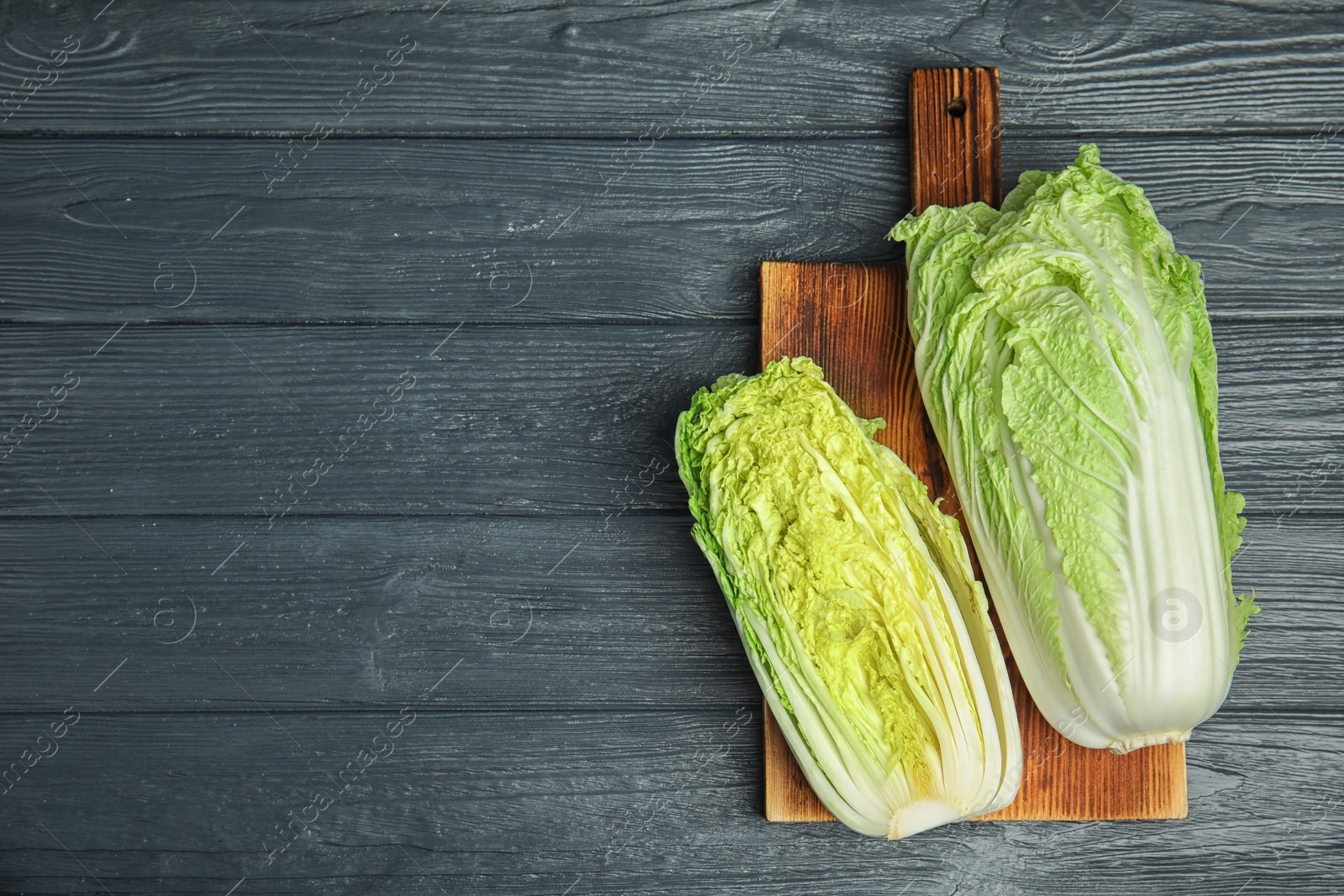 Photo of Fresh ripe cabbages on wooden board