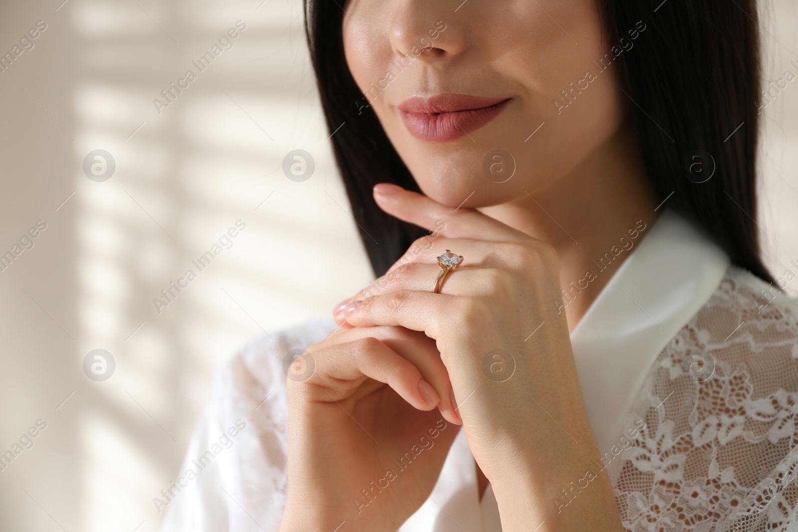 Photo of Young woman wearing beautiful engagement ring, closeup