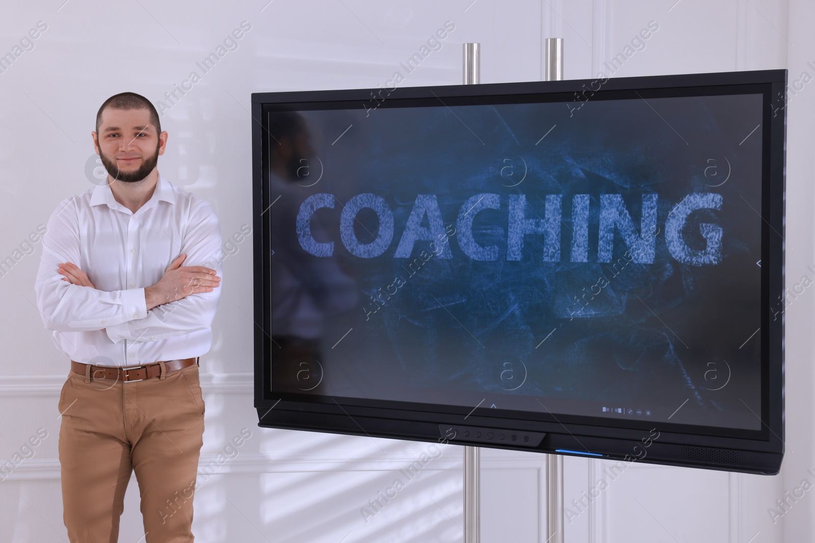 Photo of Business trainer near interactive board in meeting room