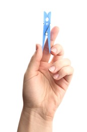 Woman holding light blue plastic clothespin on white background, closeup