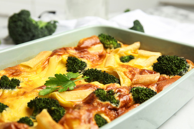 Photo of Tasty broccoli casserole in baking dish, closeup