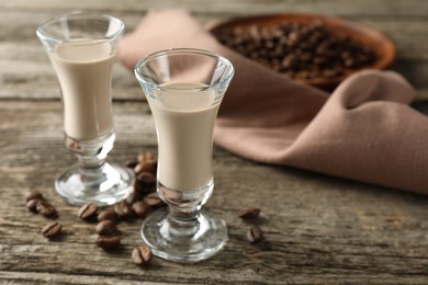 Coffee cream liqueur in glasses and beans on wooden table