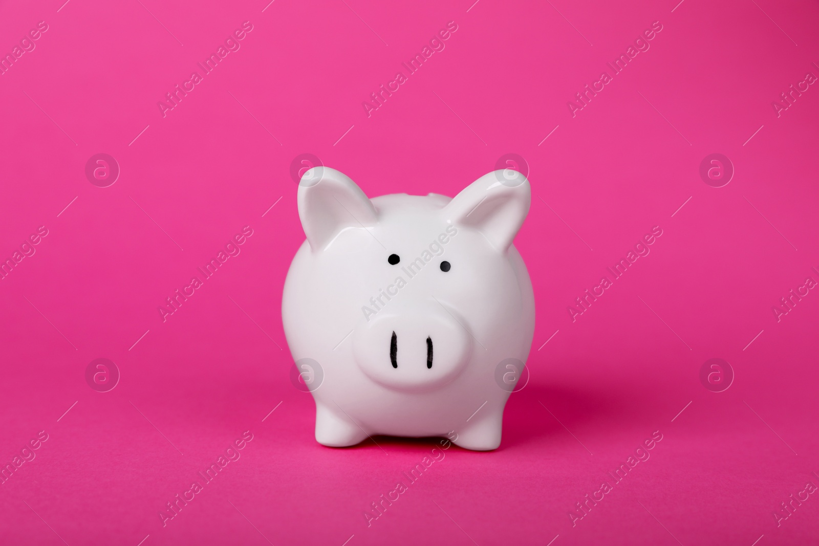 Photo of Ceramic piggy bank on pink background. Financial savings