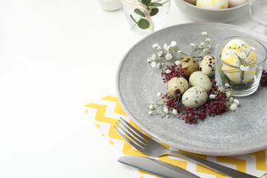 Festive Easter table setting with beautiful floral decor. Space for text