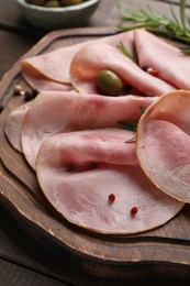 Slices of delicious ham served on wooden table