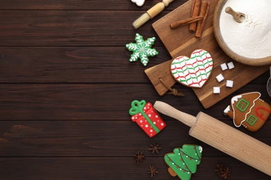 Photo of Delicious Christmas cookies and ingredients on wooden table, flat lay with space for text