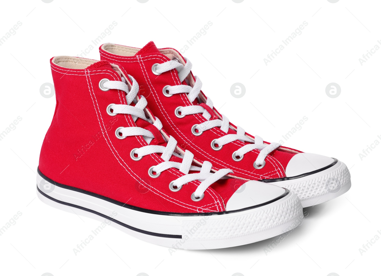 Photo of Pair of new red stylish high top plimsolls on white background