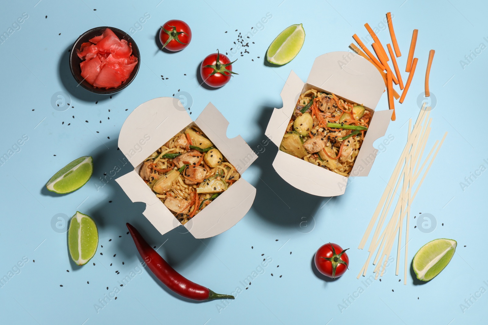 Photo of Flat lay composition with noodle wok and ingredients on light blue background