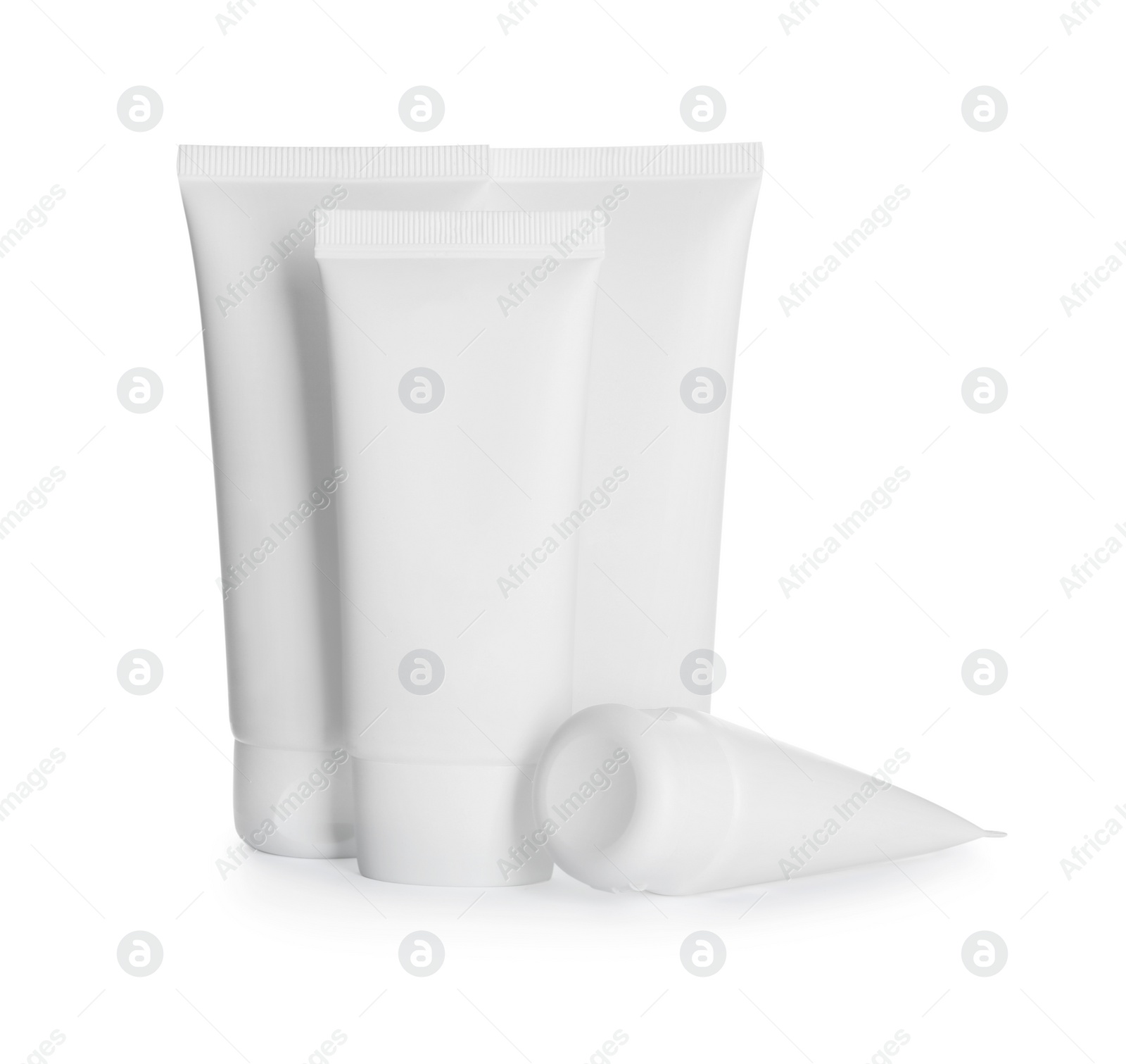 Photo of Blank tubes of cosmetic products on white background