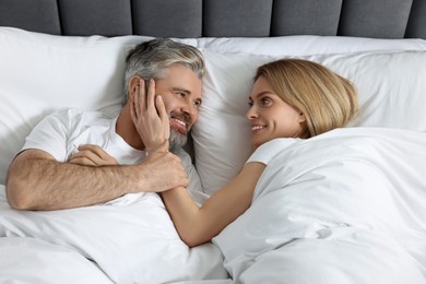 Photo of Lovely mature couple in bed at home, above view