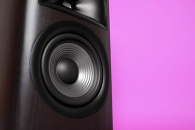 Photo of One wooden sound speaker on violet background, closeup. Space for text