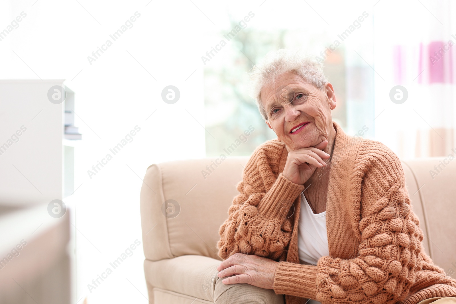 Photo of Portrait of beautiful grandmother in living room