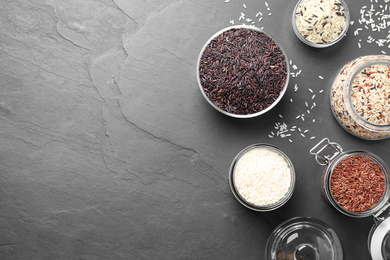 Photo of Flat lay composition with brown and polished rice on grey table. Space for text