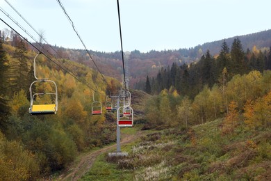 Photo of Chairlift with comfortable seats at mountain resort