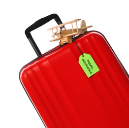 Photo of Red suitcase with TRAVEL INSURANCE label on white background