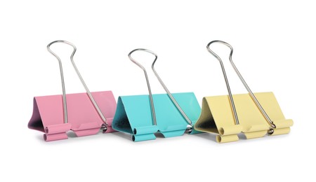 Photo of Colorful binder clips on white background. Stationery item
