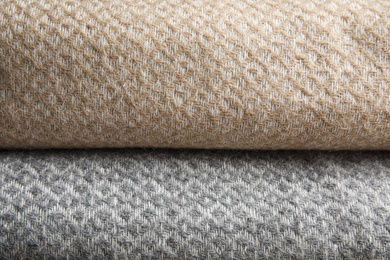 Beige and grey woolen plaids as background, closeup