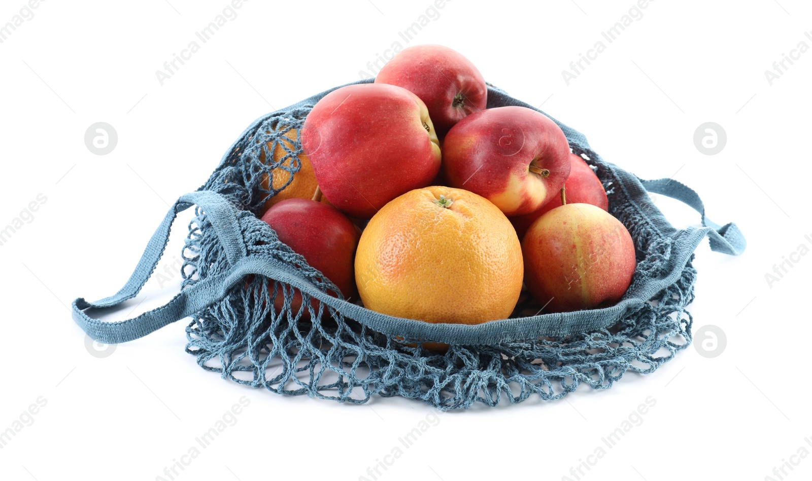 Photo of String bag with apples and orange isolated on white
