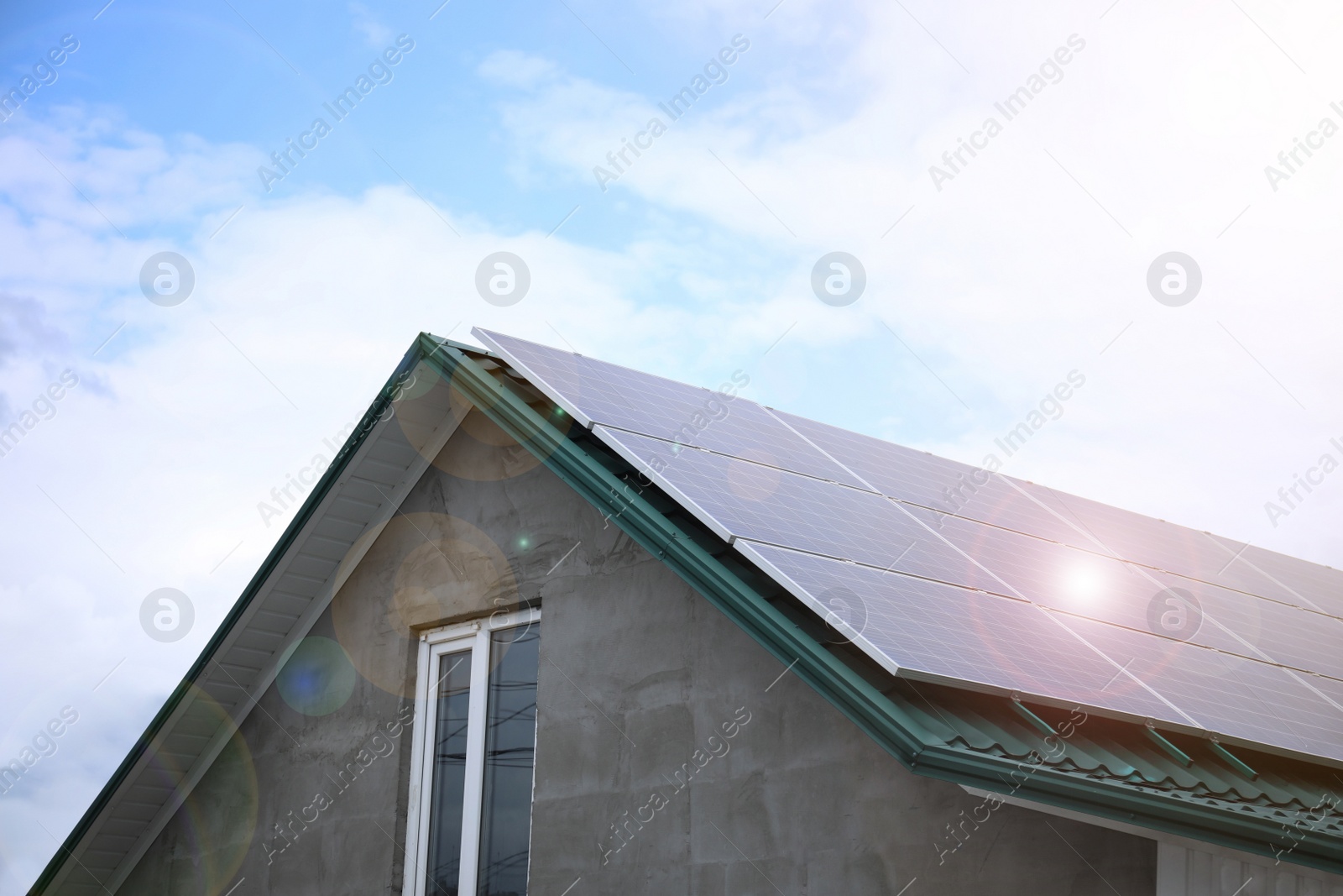 Photo of Closeup view of building with installed solar panels on roof. Alternative energy source