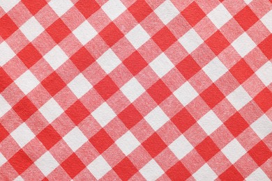 Red checkered tablecloth as background, top view