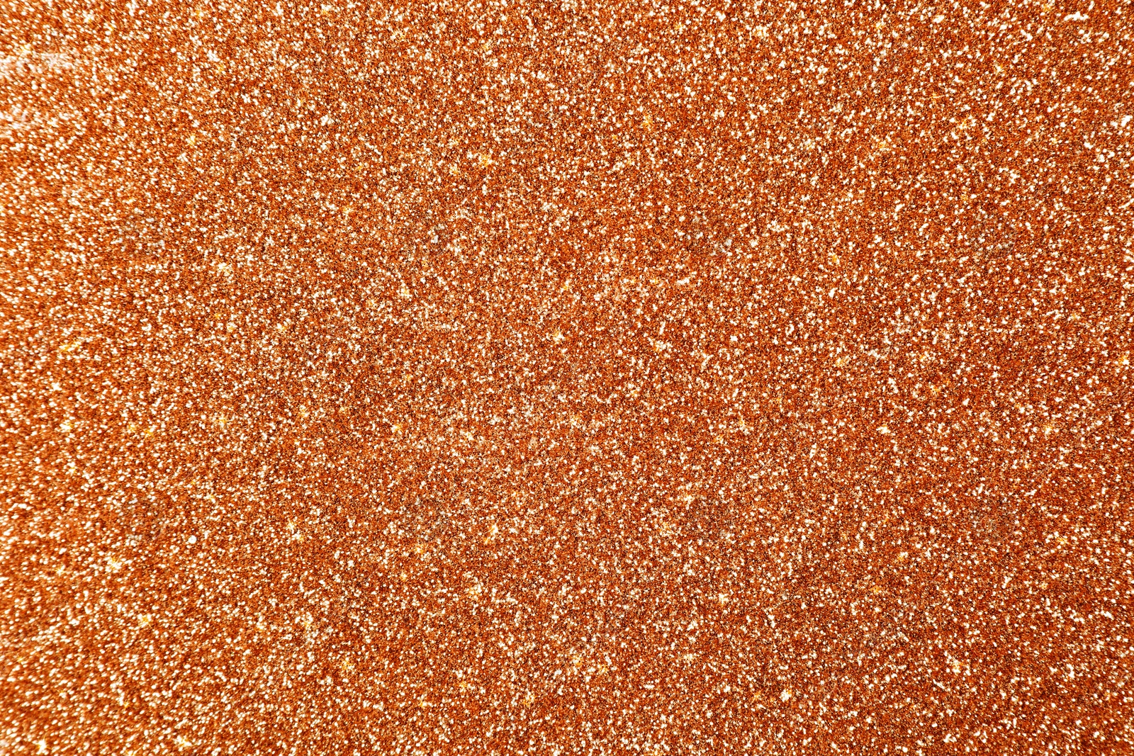 Image of Beautiful shiny orange glitter as background, closeup