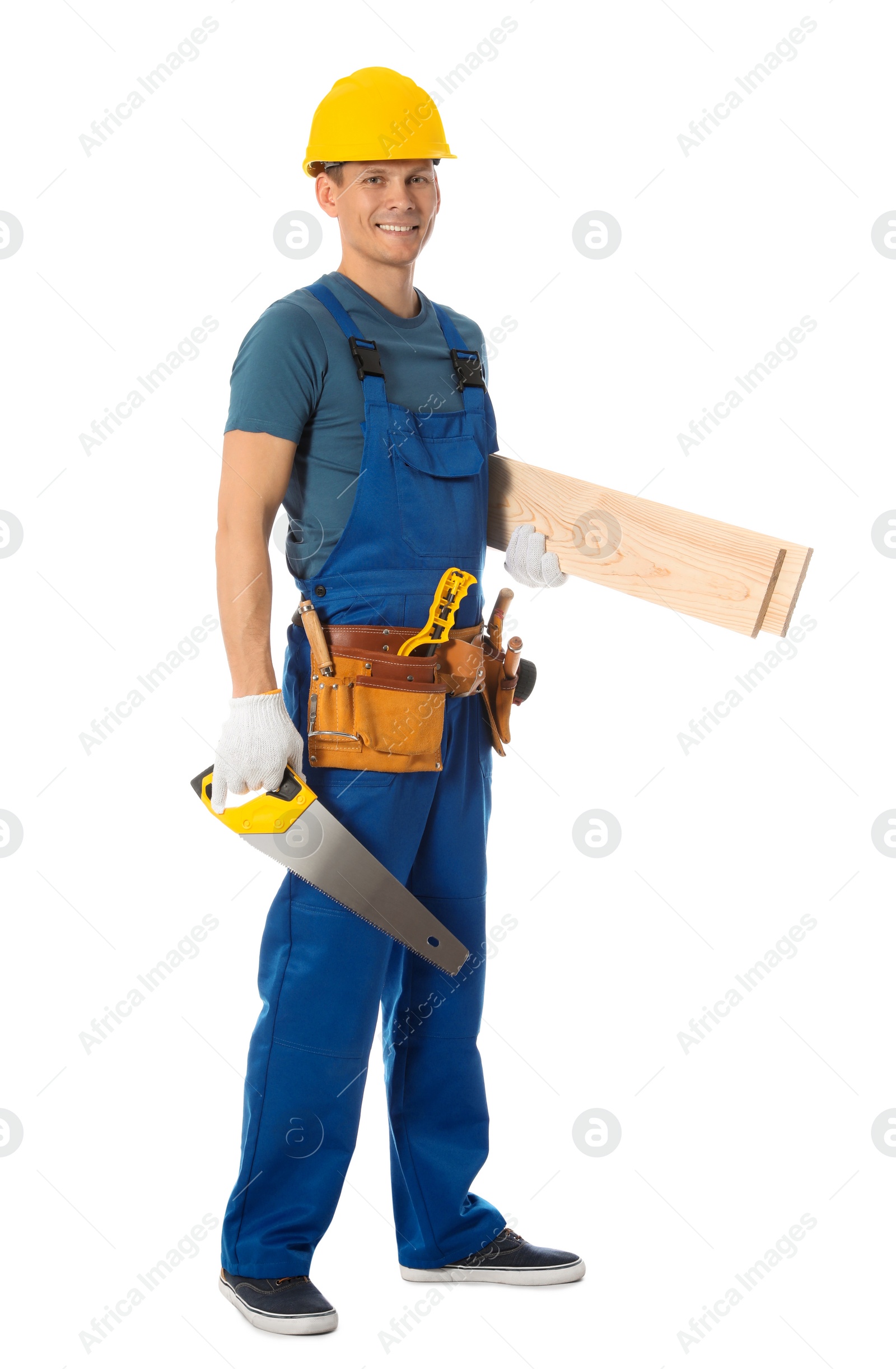 Photo of Handsome carpenter with wooden planks and hand saw isolated on white