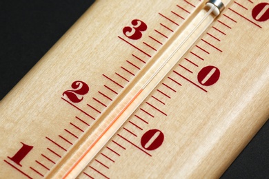 Photo of Weather thermometer on dark background, closeup view