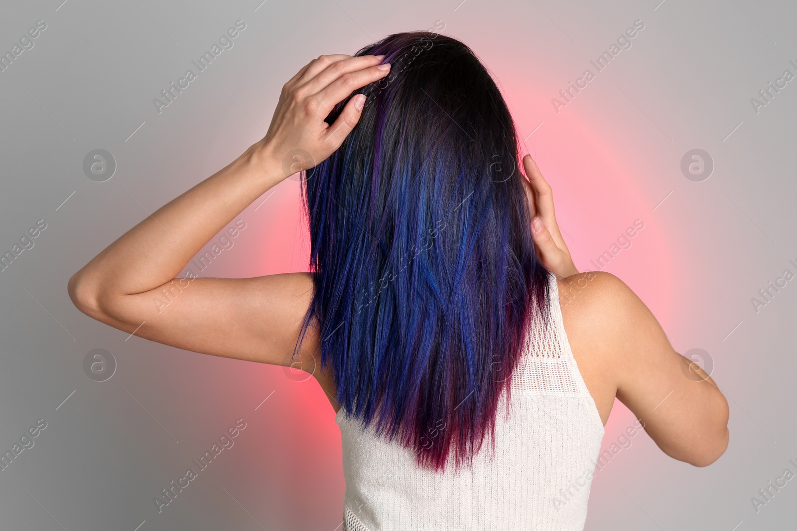 Photo of Young woman with bright dyed hair on color background