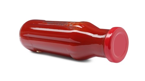 Glass bottle of tasty ketchup isolated on white