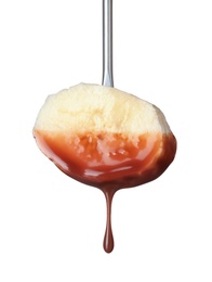 Banana with chocolate on fondue fork against white background