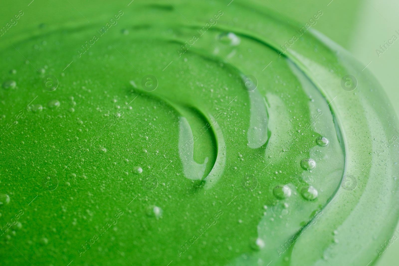 Photo of Texture of green shower gel as background, closeup