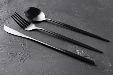 Set of beautiful cutlery on black table