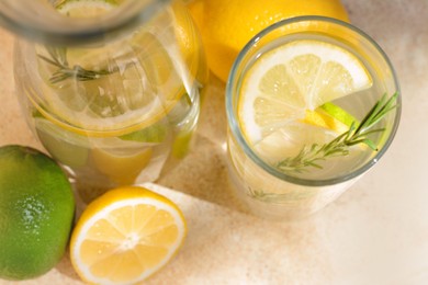 Photo of Summer refreshing lemonade drink with ingredients on light table, closeup