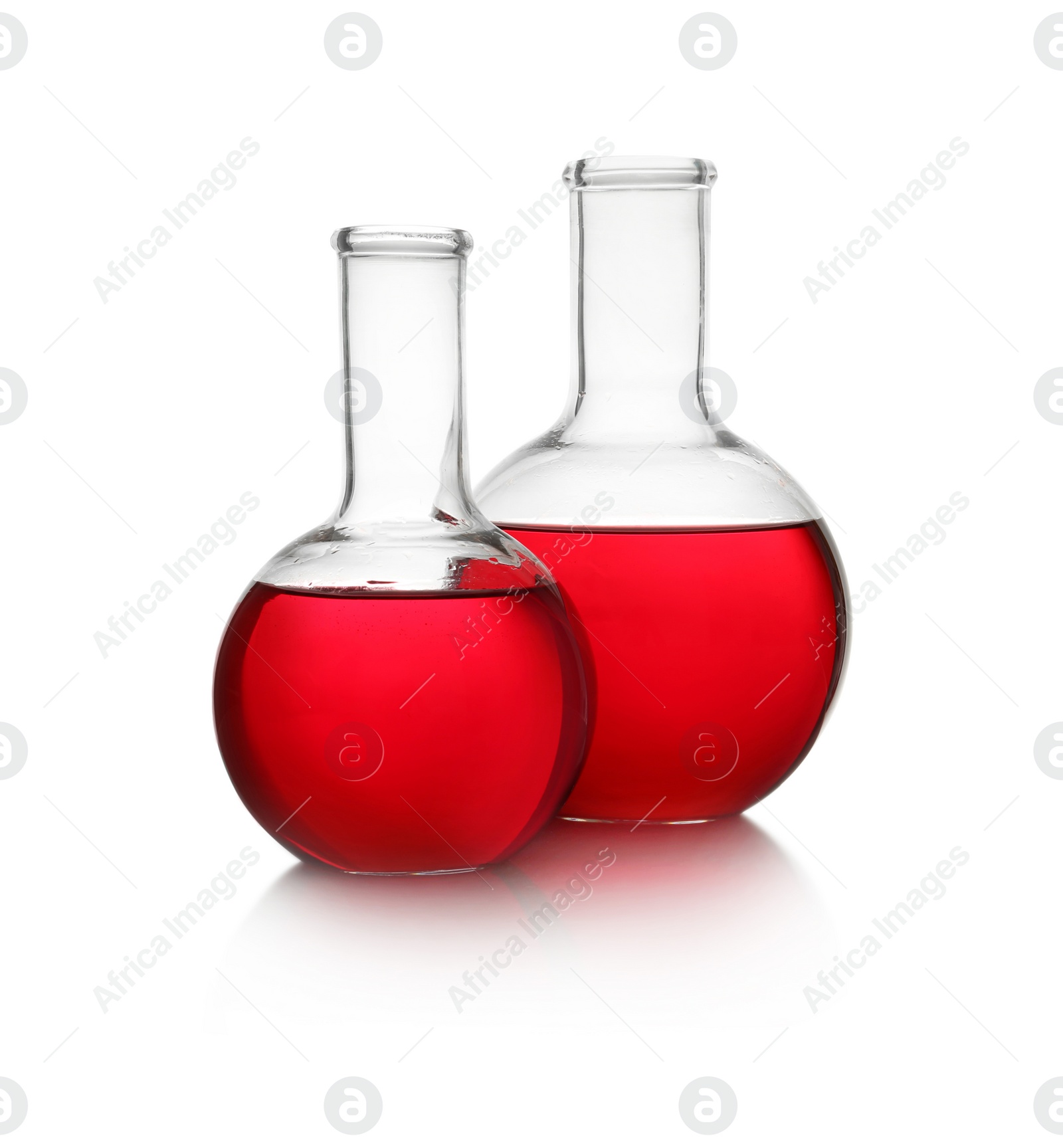 Photo of Florence flasks with red liquid on white background. Laboratory glassware