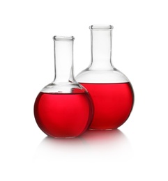 Photo of Florence flasks with red liquid on white background. Laboratory glassware