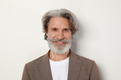 Portrait of handsome mature man on light background