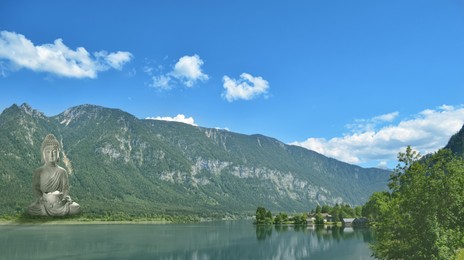 Image of Majestic Buddha sculpture near lake and mountains on sunny day 