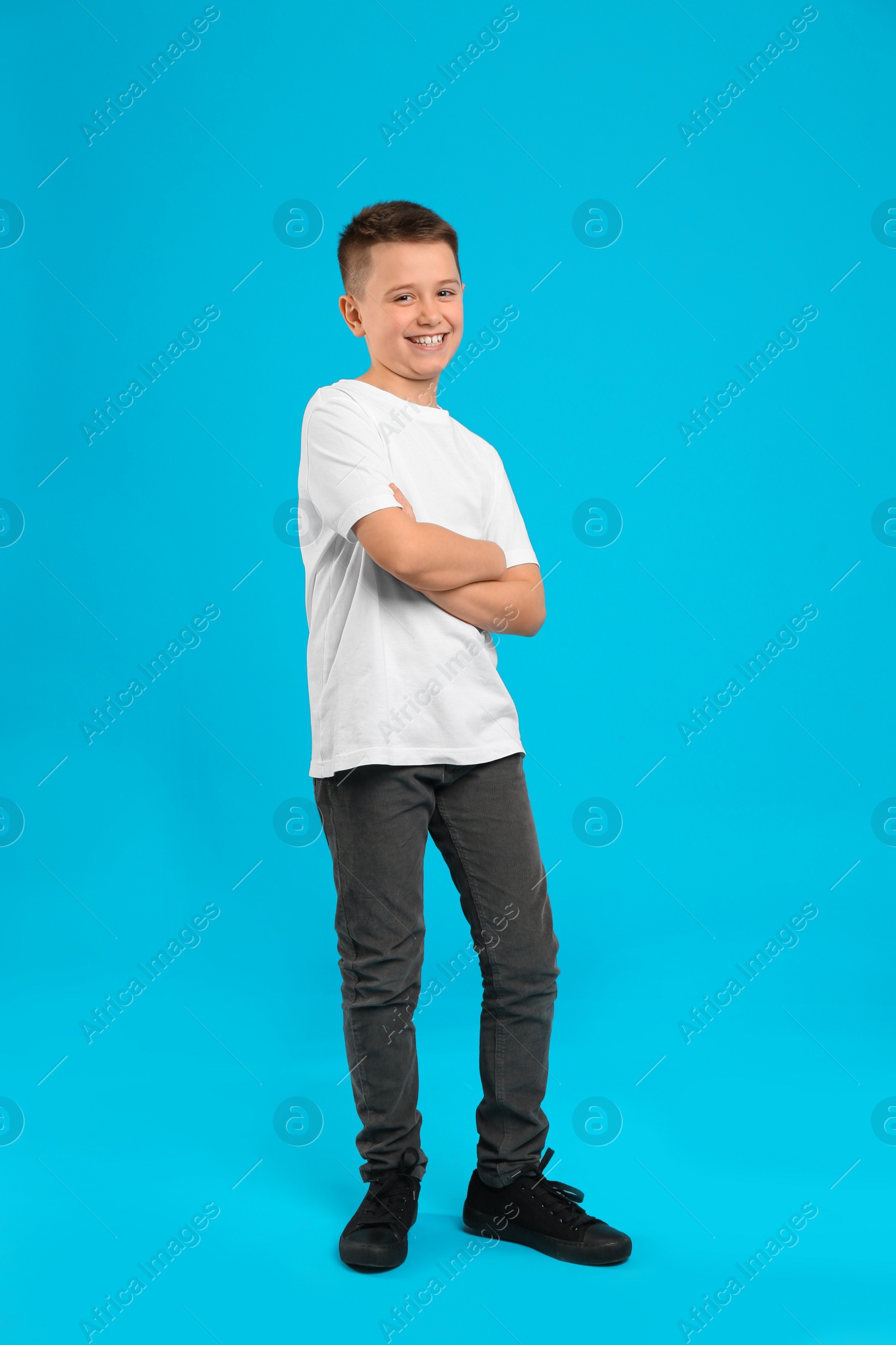 Photo of Full length portrait of preteen boy on light blue background